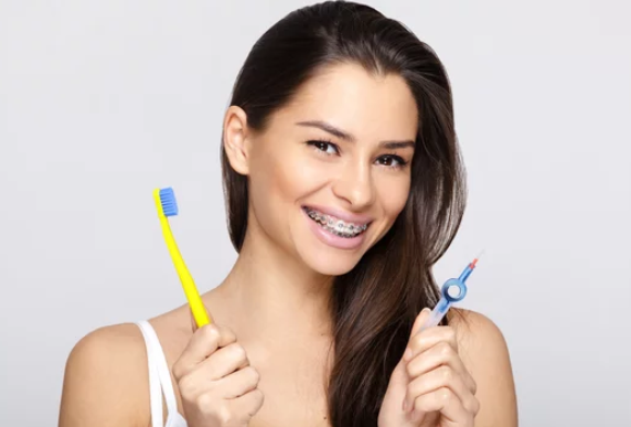 a girl holding toothbrushes
