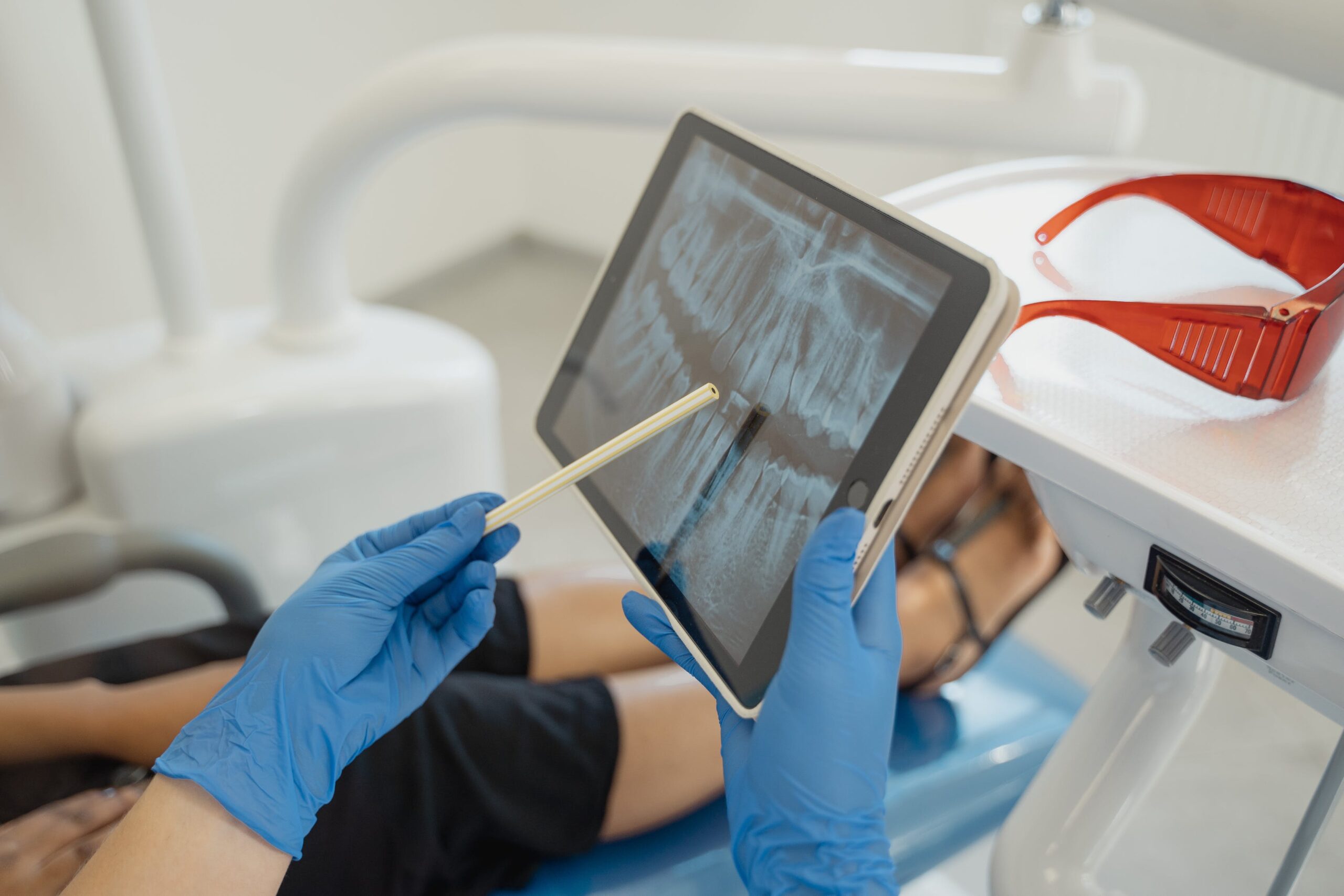 a dentist showing an x-ray on tablet