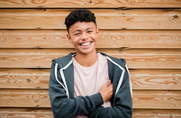 a smiling teen boy with braces