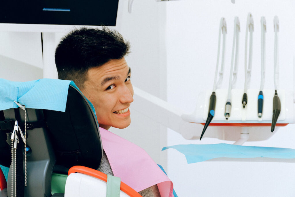 a happy patient sitting on the dentist's chair