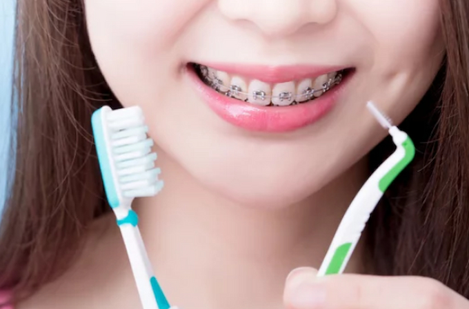 a person holding toothbrushes