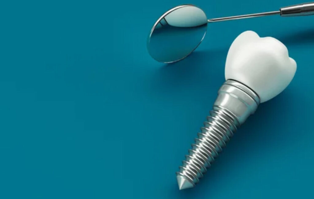 dental mirror and implant on the blue background