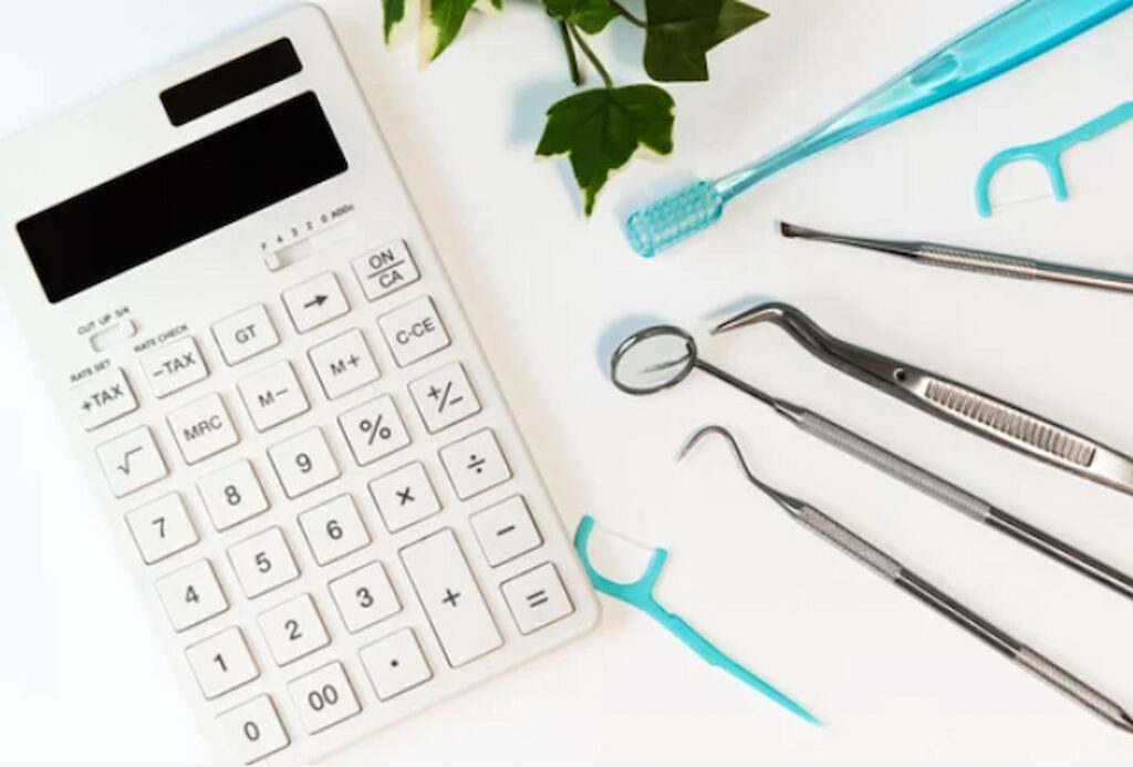white calculator and oral hygiene tools