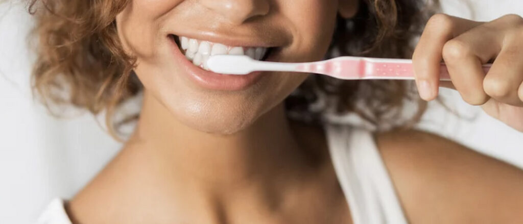 a woman brushing her teeth
