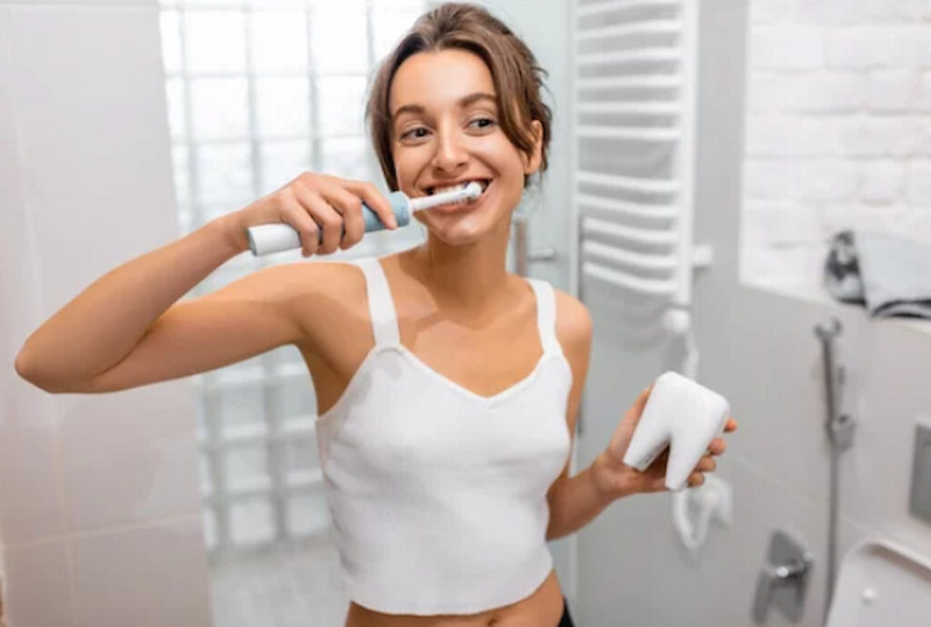 a woman brushing her teeth in the bathroom