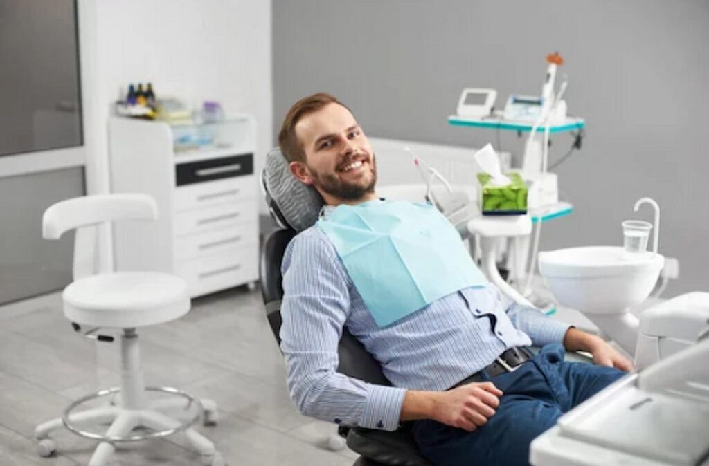 a man sitting on the chair in the dentist's office