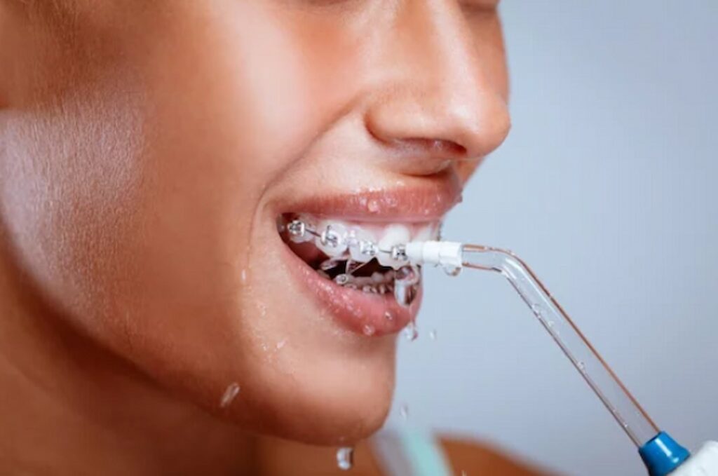 a person flossing with water tool