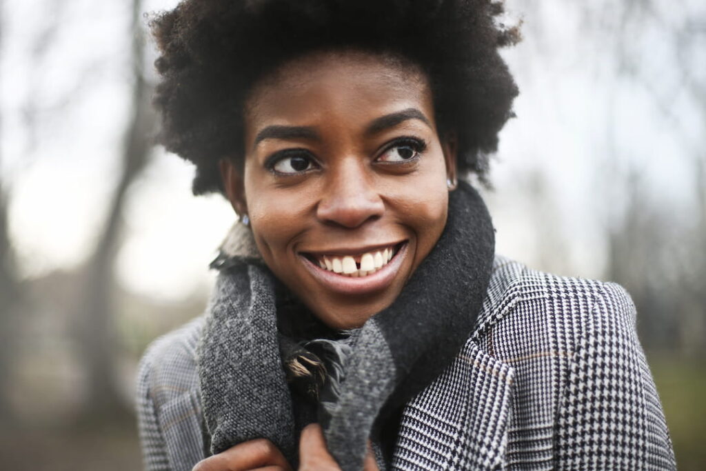 a smiling woman with a scarf around her neck