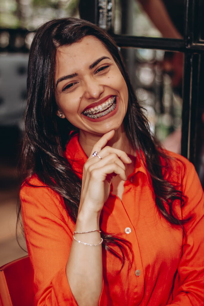 a smiling woman wearing braces