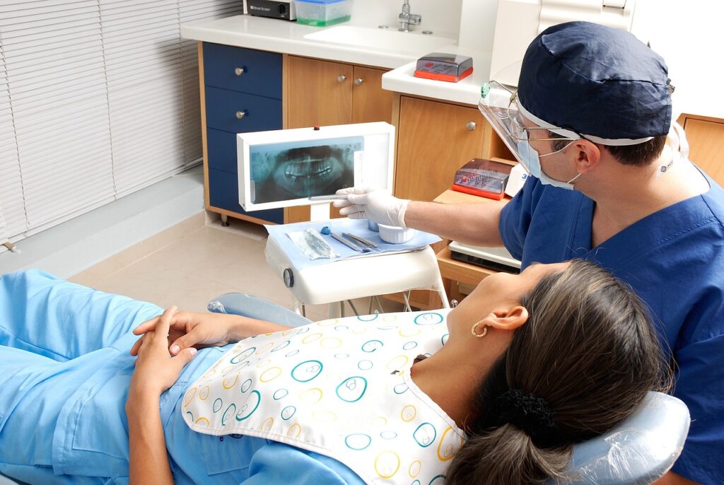 Dentist examining a patient’s teeth with professional dental tools at OC Dental Center in Santa Ana, California