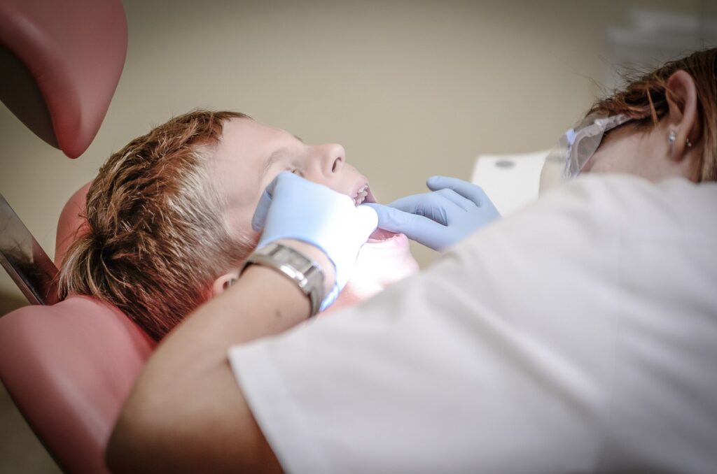 Dentist performing a dental examination on a patient in a modern dental office at OC Dental Center in Santa Ana, California