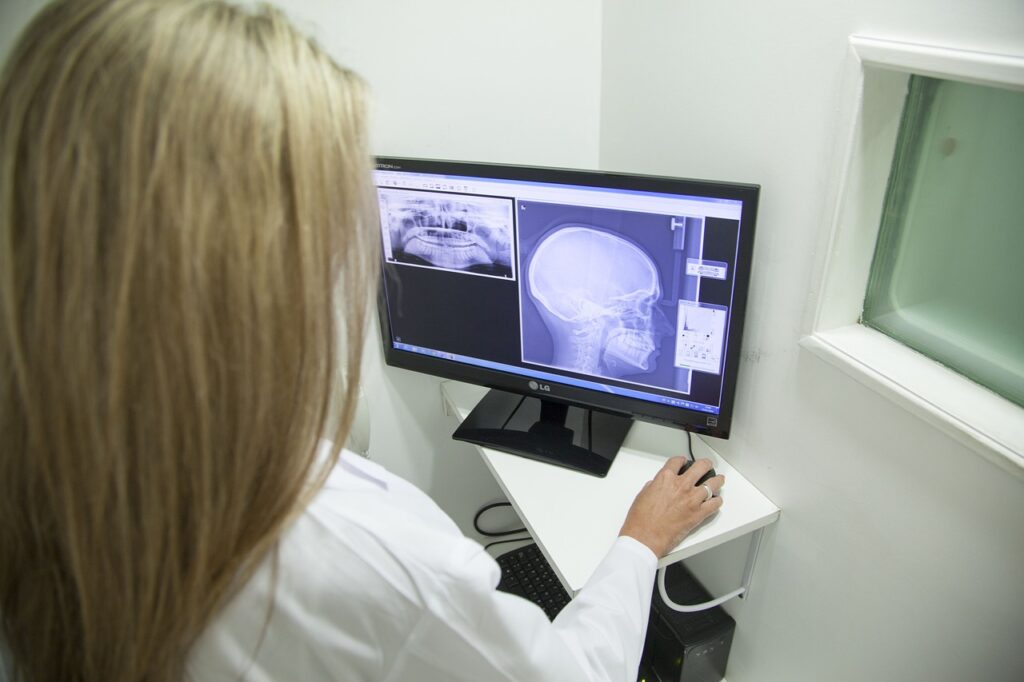 Dental X-ray of human jaw and skull displayed on computer screen in dentist office