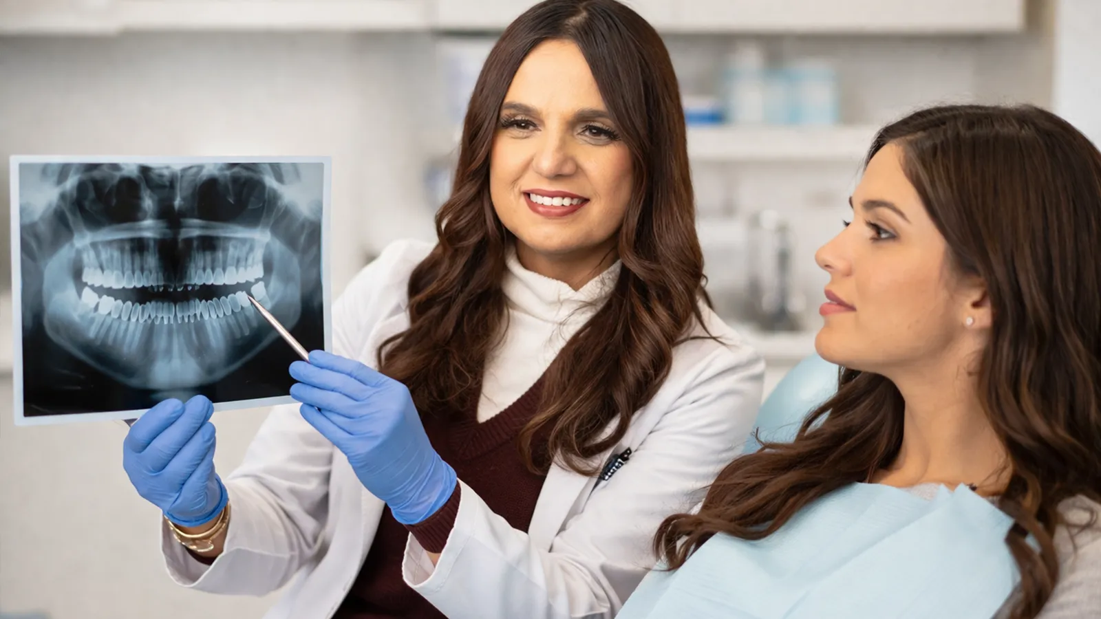 Dentist reviewing dental x-ray with patient at OC Dental Center